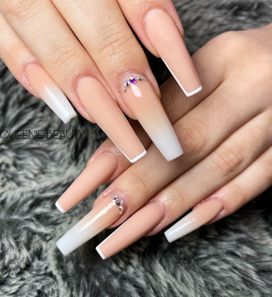 23 Latest Nude French Nail Designs To Try In 2024! 29 Nude And White Ombre Coffin Nails With Rhinestones