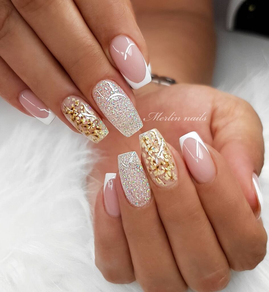 30 Latest White And Gold Nail Ideas To Try In 2024! 26 White French Nails With Gold Flowers And Glitters