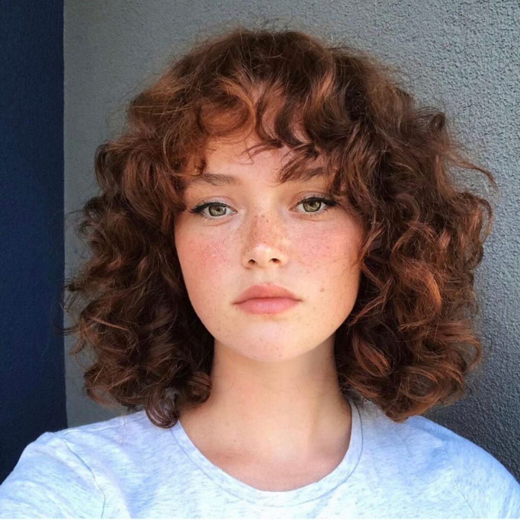 25 Short Layered Haircut Ideas to Revamp Your Look in 2024 17 Curly Shoulder Shag