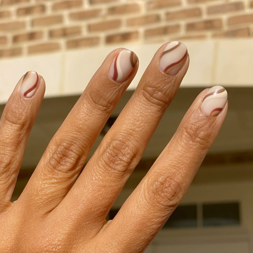 Find Your Style with 28 Beige Nail Designs of 2024 22 Beige And Brown Swirly Nails