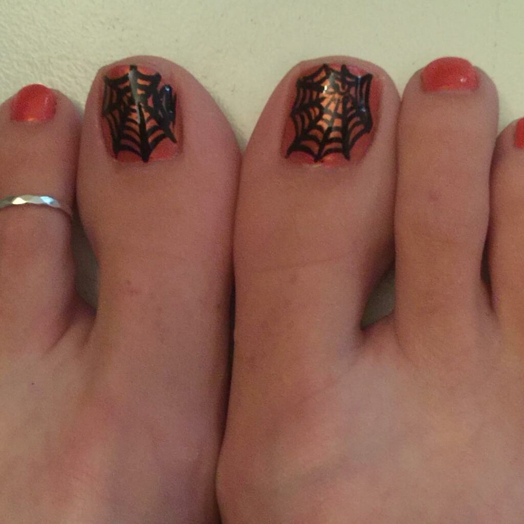 30 Spooky Halloween Pedicure Ideas to Try in 2024 21 Orange and Black Web Delight