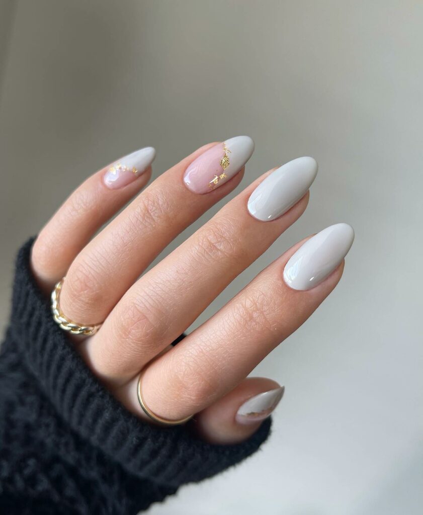 30 Latest White And Gold Nail Ideas To Try In 2024! 22 White Almond Negative Nails With Gold Glitters