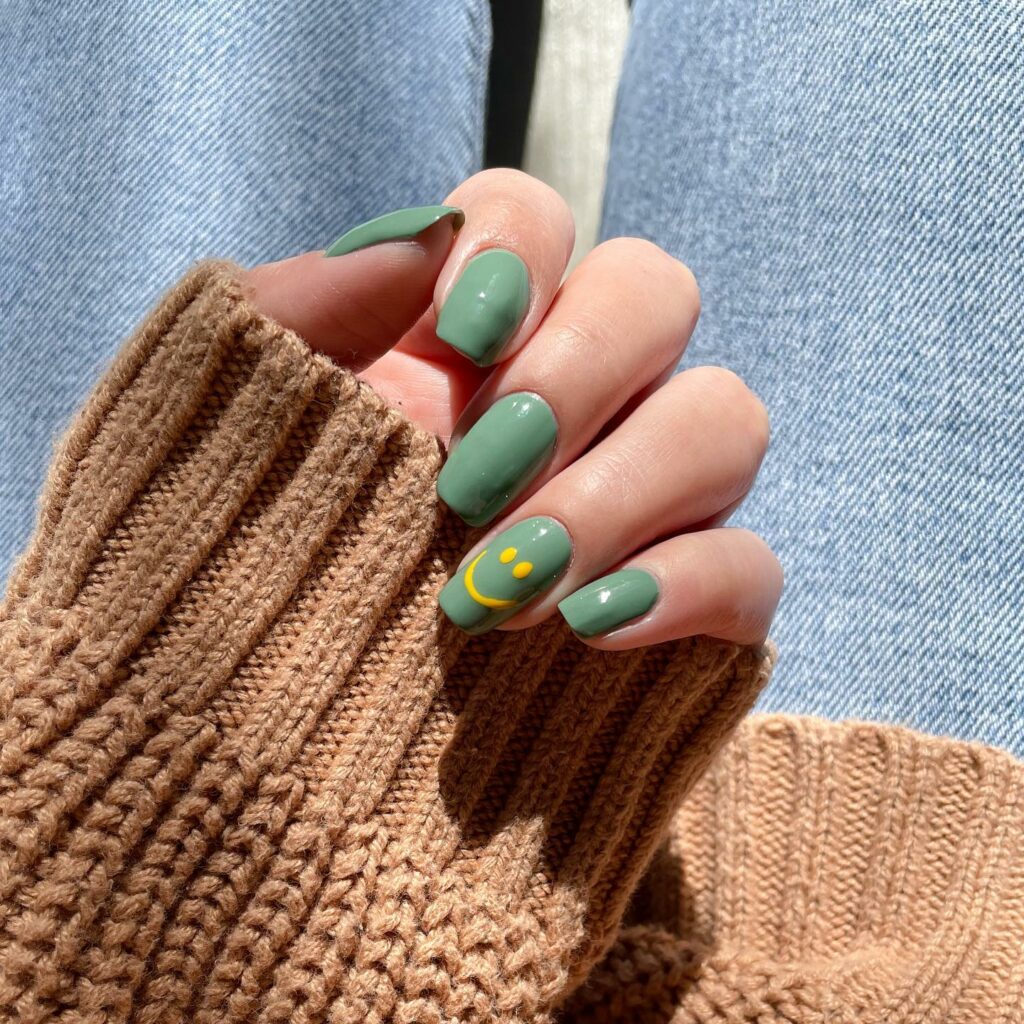 25 Latest Accent Nail Designs To Try In 2024! 19 Green Accent Nails With Smiley Design