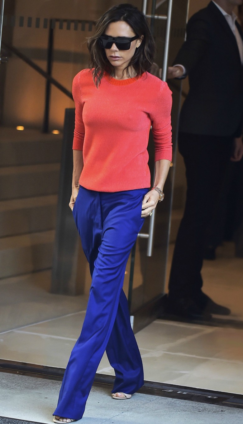Best Cashmere Jumpers 22 Victoria Beckham street style wearing orange cashmere jumper with blue trousers, sunglasses and heels