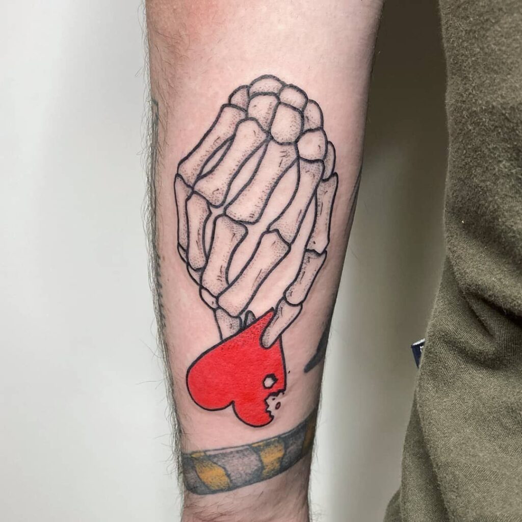 34 Hand Skeleton Tattoo Designs for 2024 33 Skeleton Hand Holding Heart Tattoo