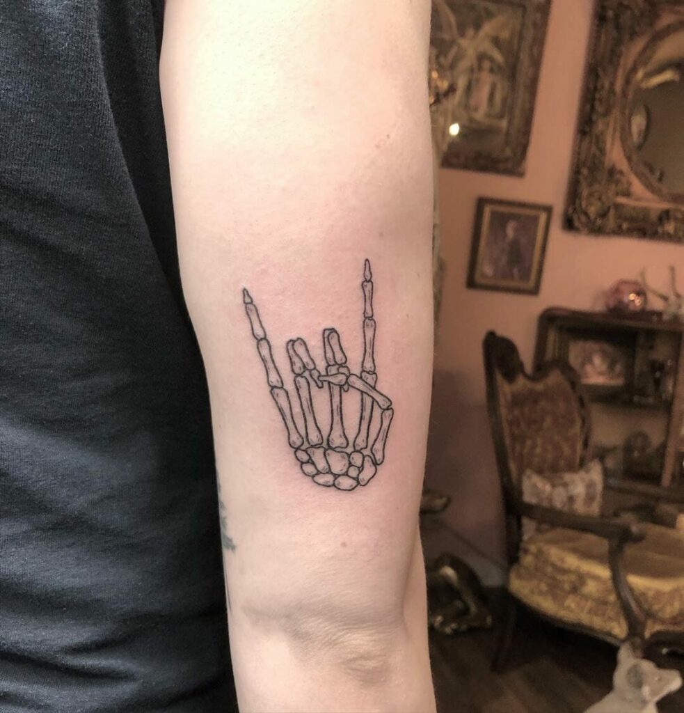 34 Hand Skeleton Tattoo Designs for 2024 29 Rock And Roll Skeleton Hand Tattoo