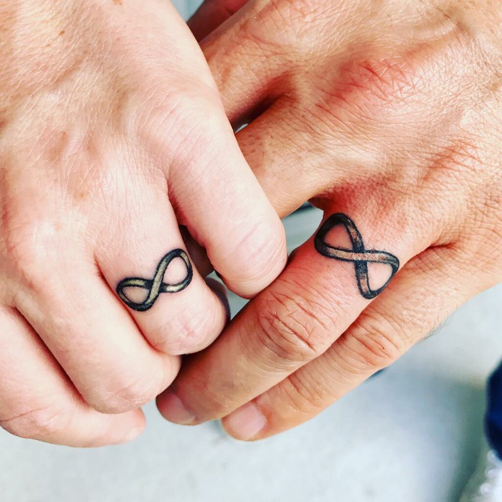 10 Best Wedding Ring Tattoo Ideas - Updated For 2024 13 Infinity Traditional Wedding Ring Tattoo
