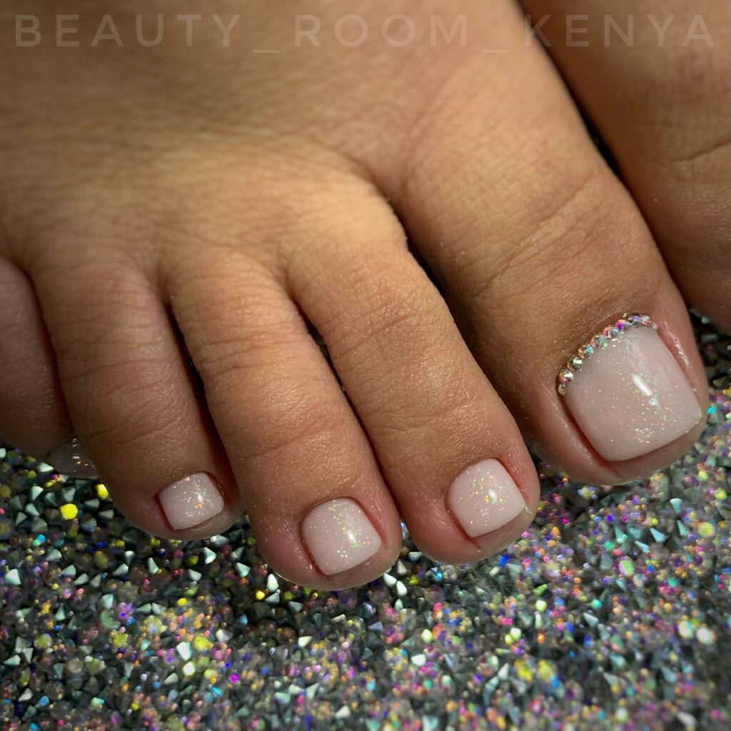 Add Sparkle with 25 Sparkly Toe Nails for 2024 23 Nude Color Pedicure With Glitters On Base