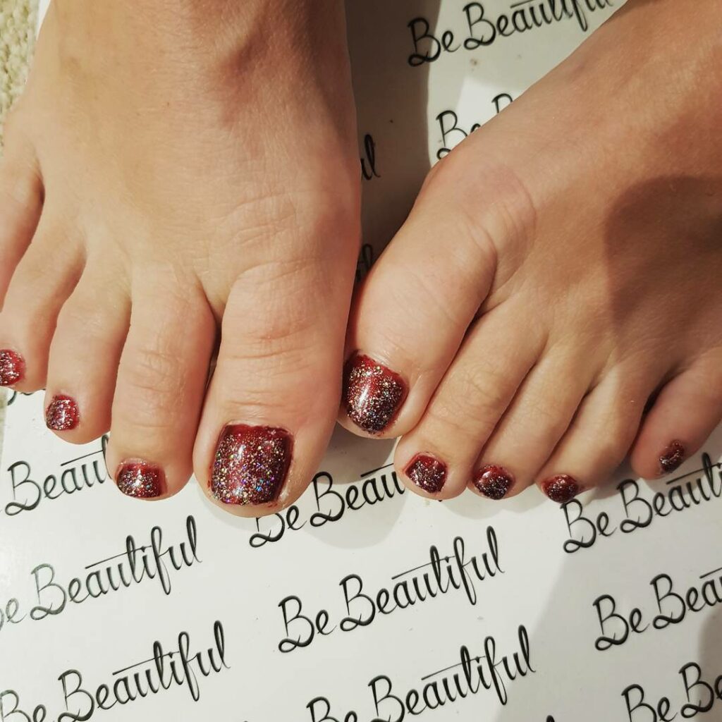 30 Festive Christmas Pedicure Ideas to Experiment with in 2024 26 Red Nails with Glitter Accents