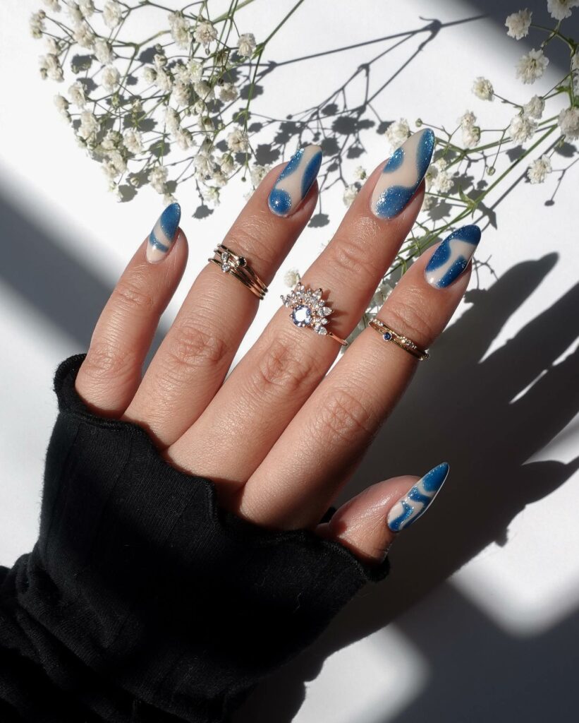 20 Latest Negative Space Nail Ideas To Try In 2024! 24 Negative Space Blue Almond Nails With Glitter