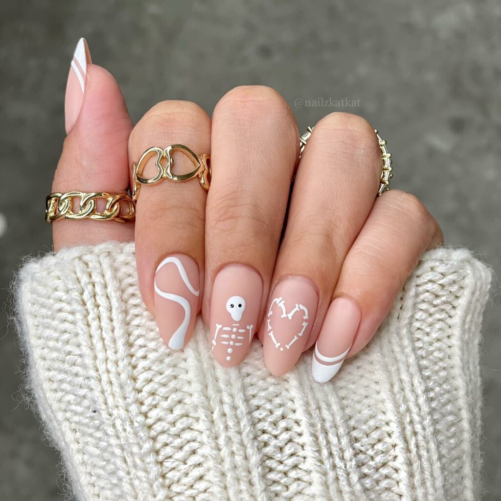 23 Latest Nude French Nail Designs To Try In 2024! 27 Matte Nude And White Nails With Skeleton, Heart And Swirl