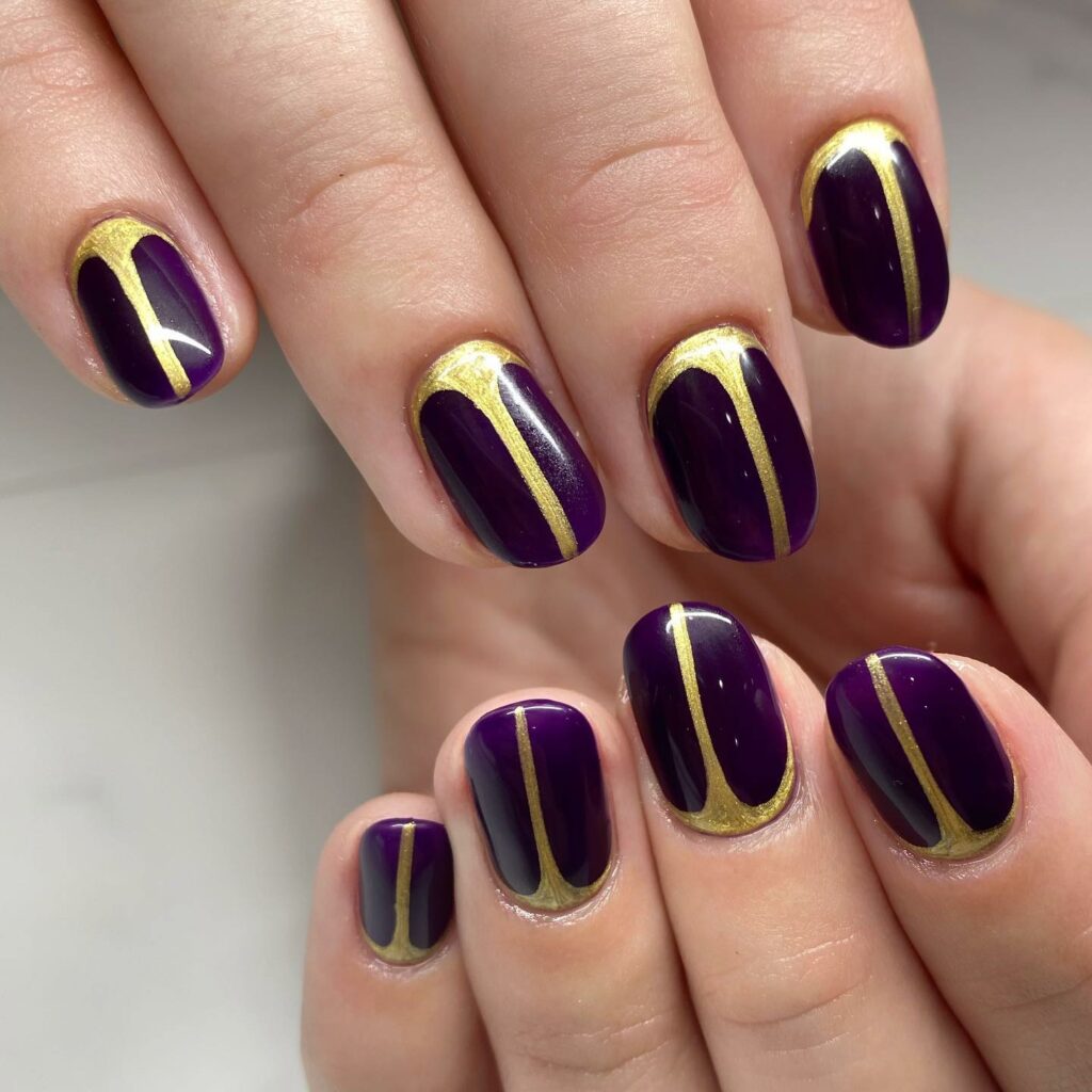 20 Latest Purple And Gold Nail Ideas To Try In 2024! 15 Short Dark Purple Nails With Gold Line Design