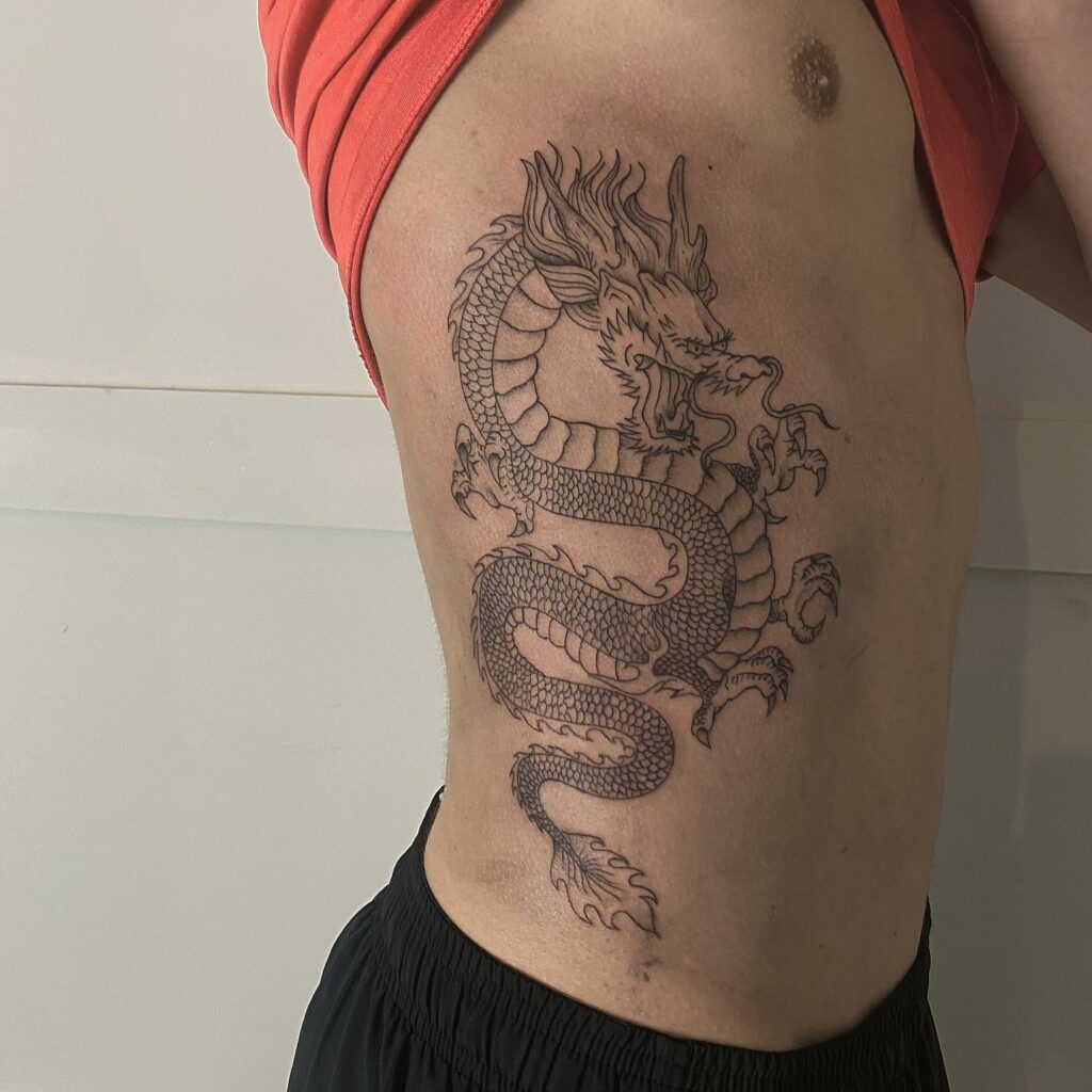 TOP 10 RIB TATTOOS DESIGNS FOR 2024 18 Dragon Rib Tattoo