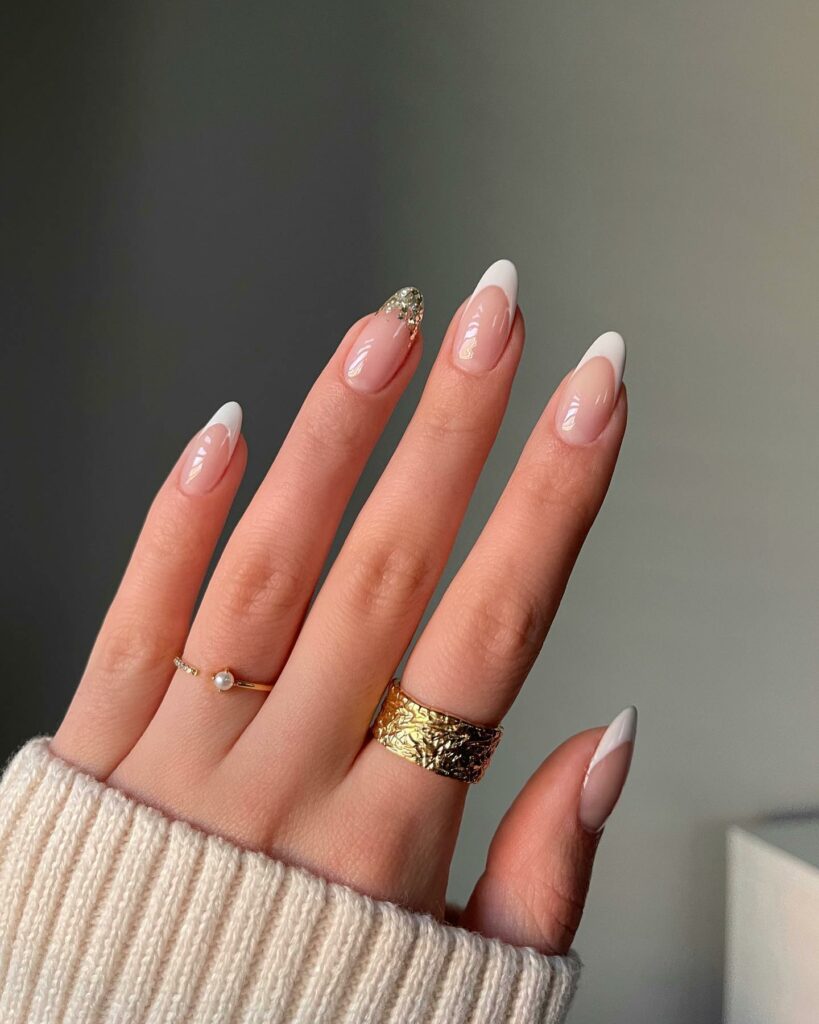 25 Latest Accent Nail Designs To Try In 2024! 23 White French With Gold Glitter Tip Accent Nails Design
