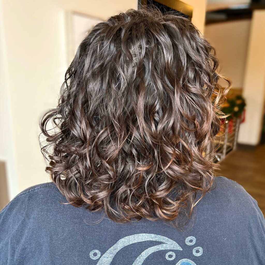 25 Curly Hair Perm Ideas to Transform Your Look in 2024 22 Medium Cut with Tousled Perm Curls
