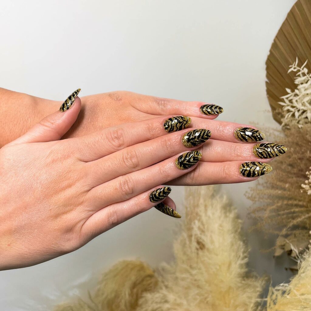 33 Latest Party Nail Ideas To Try In 2024! 44 Gold Party Nails With Black Pattern Design