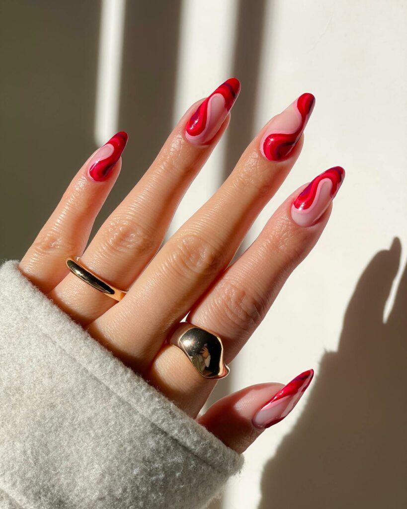 30 Latest Almond French Tip Nail Designs To Try In 2024! 16 Red Swirls Glitter Almond French Nails