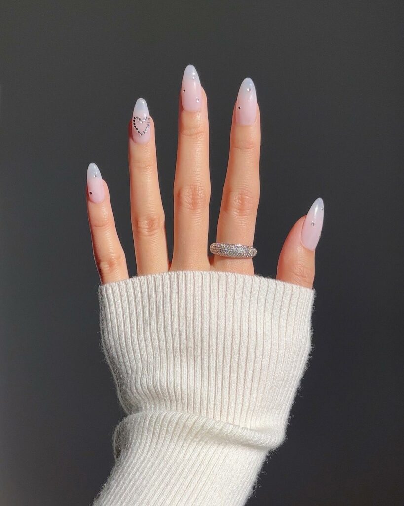 25 Latest Accent Nail Designs To Try In 2024! 14 White Accent Nails With Rhinestones And Heart