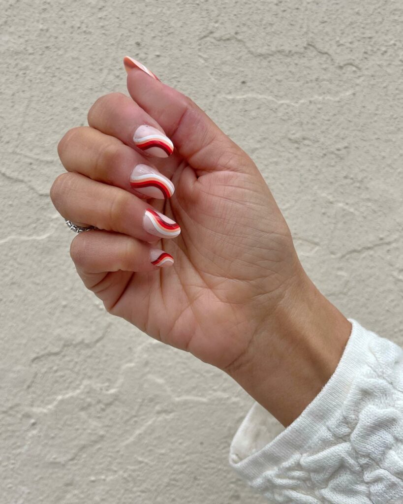 20 BEST 70S NAIL DESIGNS TO TRY IN 2024! 16 Simple White And Red 70s Swirl Nails