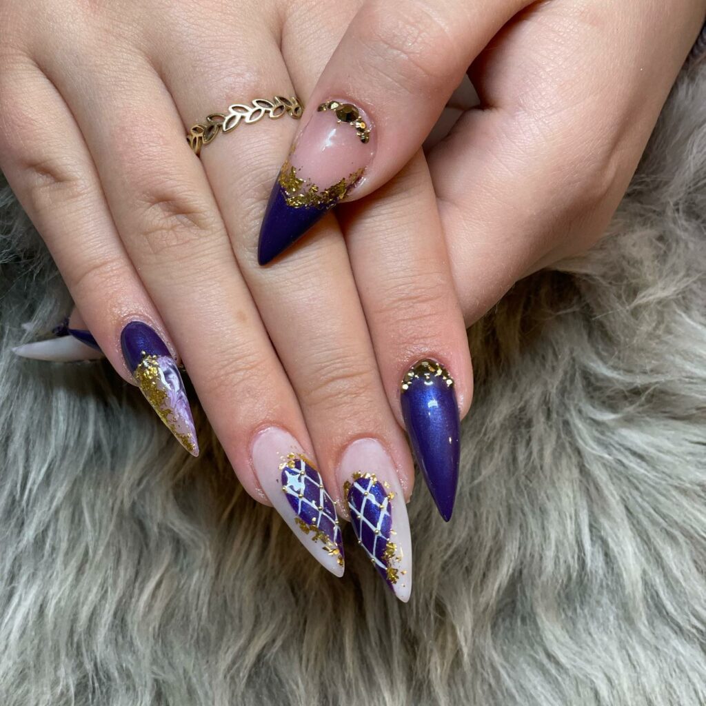 20 Latest Purple And Gold Nail Ideas To Try In 2024! 22 Dark Purple Stiletto Nails With Net And Gold Flakes Design