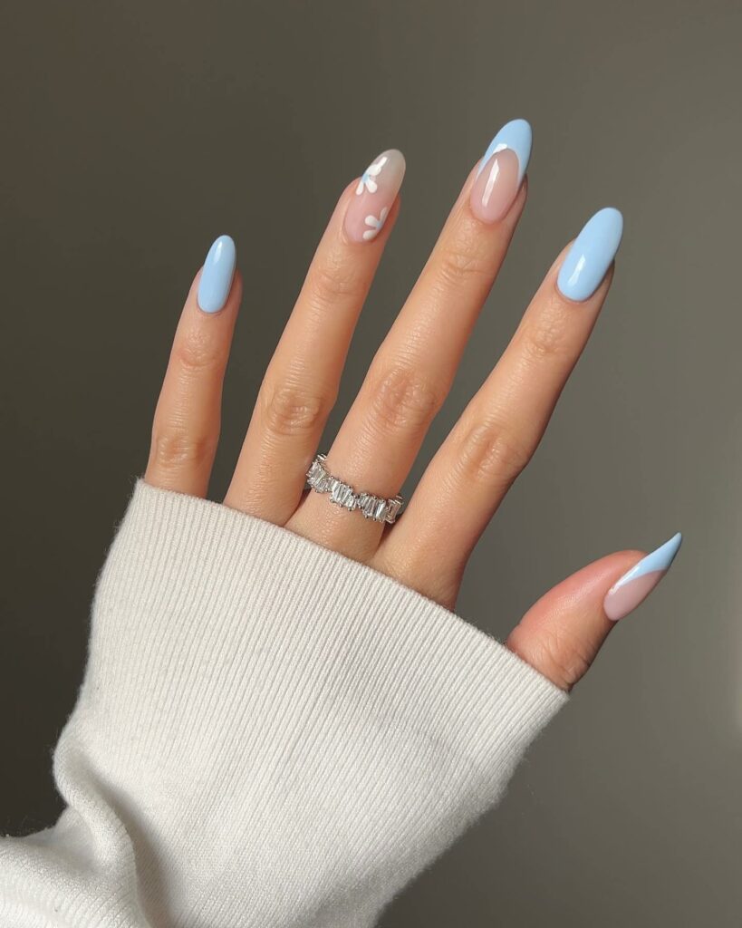 20 Latest Blue Almond Nails Ideas To Try In 2024! 11 Light Blue Almond Nails With French And Flower Design