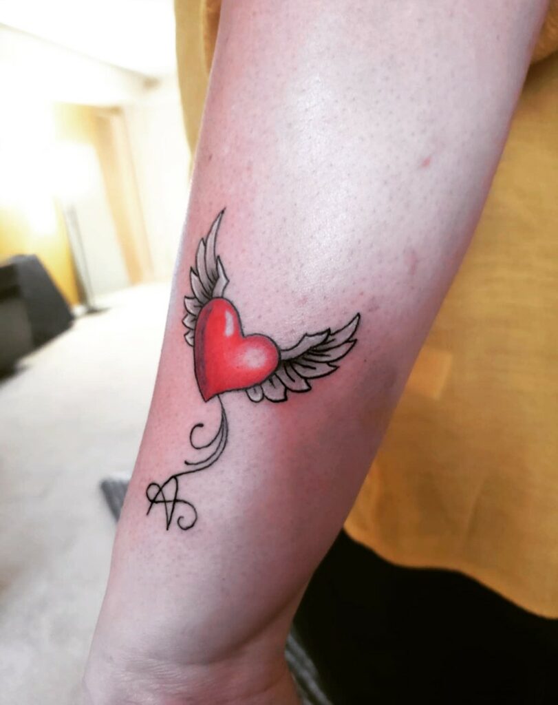 TOP 10 WING TATTOOS + MEANINGS WE'VE SEEN IN 2024 19 Heart with Wings Tattoo