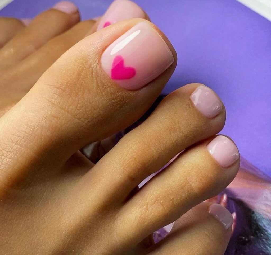 Get Playful with 30 Heart Toenail Pedicure Ideas for 2024 19 Pink Nail Art On Nude Pedicure