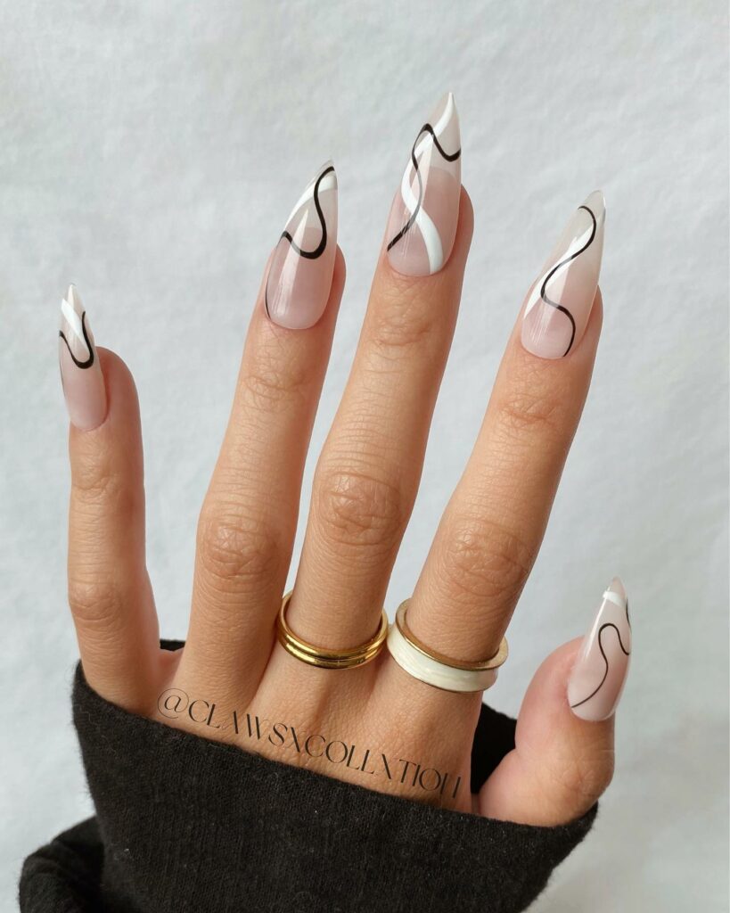 20 Latest Negative Space Nail Ideas To Try In 2024! 12 Negative Space Nails Stiletto Nails With Black And White Swirl Design