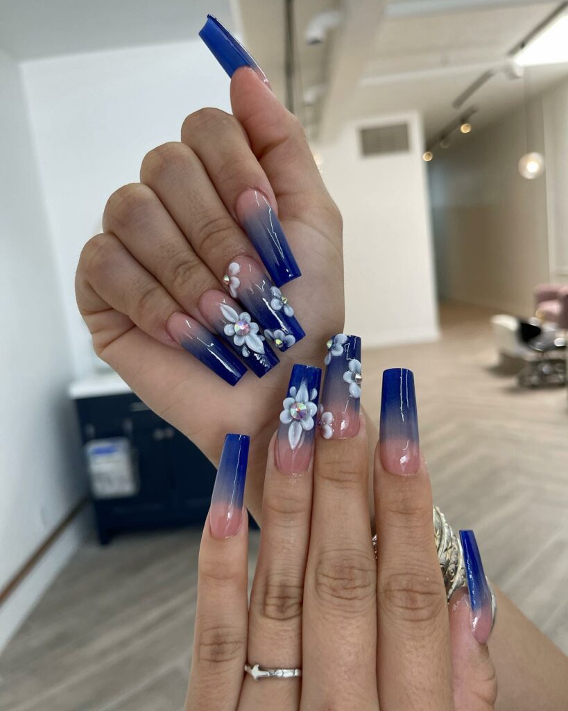 20 Latest Royal Blue Ombre Nail Designs To Try In 2024! 26 Royal Blue Ombre Coffin Nails With 3D Flower Design And Rhinestones