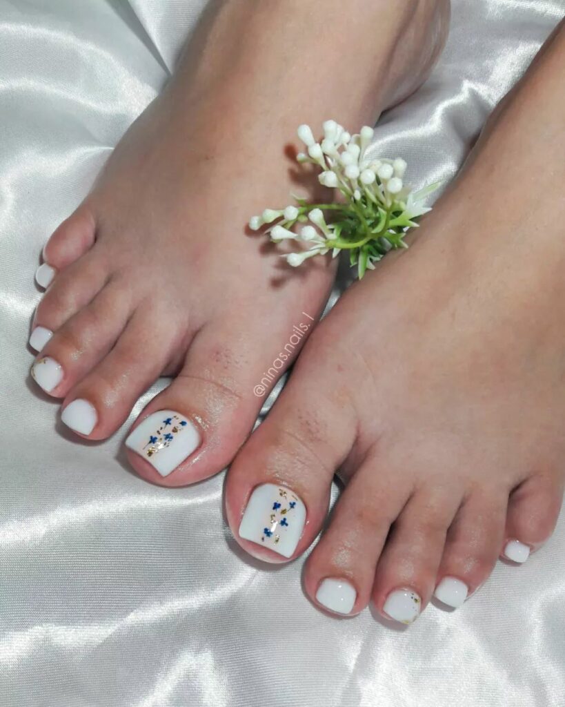 17 Latest Milky White Pedicure Designs To Try In 2024! 17 Milky White Pedicure With Blue Flowers Design