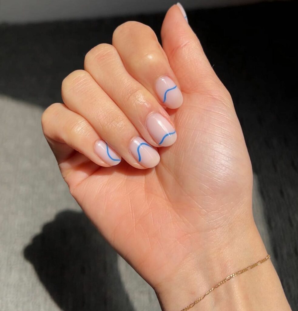 20 Latest Minimalist Nail Ideas To Try In 2024! 16 Minimalist Nude Nails With Thin Blue Swirl Design