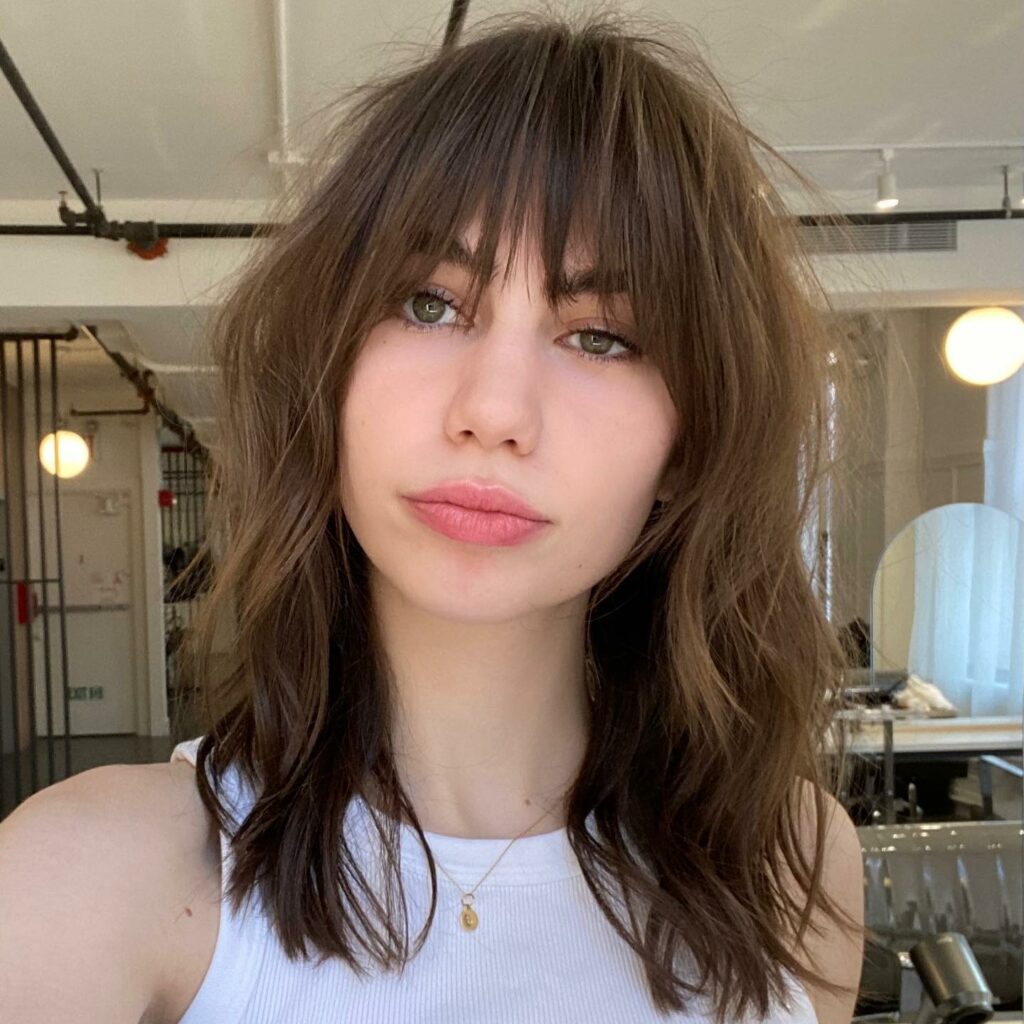 45 Wispy Long Curtain Bang Hairstyles to Try in 2024 26 Layered Medium Hair with Wispy Bangs.