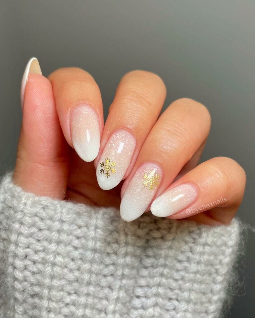 30 Latest Winter Nail Ideas To Try In 2024! 33 Winter Almond Nails With Gold Snow Flakes Design