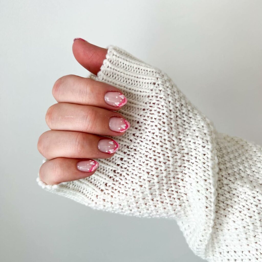 20 Latest February Nail Designs To Try In 2024! 17 Pink French February Nails With White Hearts