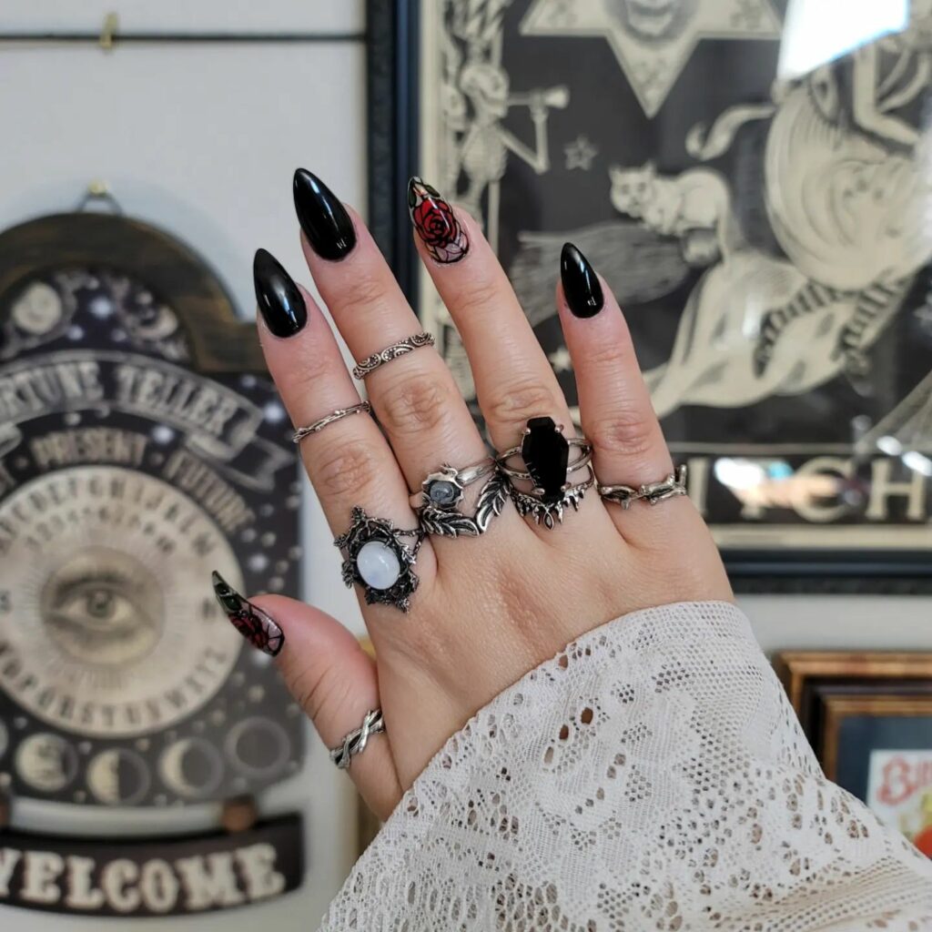 20 Latest February Nail Designs To Try In 2024! 16 Black Almond February Nails With Rose Design
