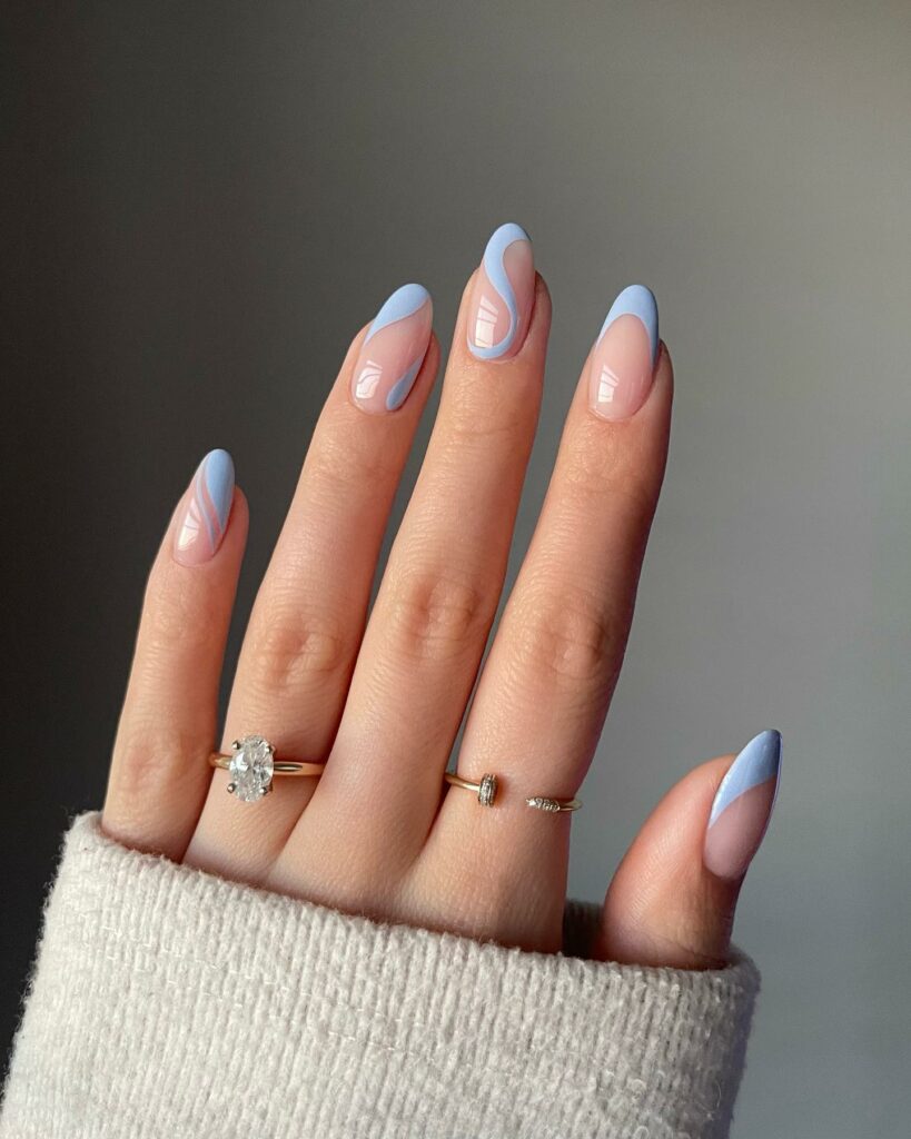 20 Latest Blue Almond Nails Ideas To Try In 2024! 14 Abstract Light Blue Almond Nails With French And Swirl Design