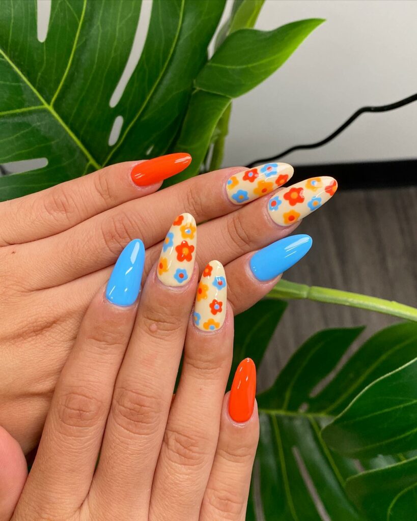 20 Latest Orange And Blue Nail Ideas To Try In 2024! 16 Orange And Blue Nails With Daisies Design