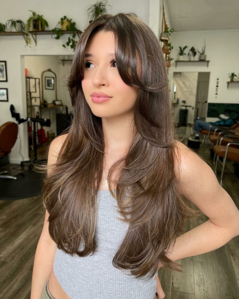 25 Butterfly Haircut Ideas to Elevate Your Style in 2024 11 Curtain Bangs and Face-Framing Layers