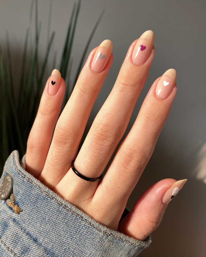 20 Latest Minimalist Nail Ideas To Try In 2024! 14 Minimalist Almond Nails With Colorful Tiny Heart And Nude French Design