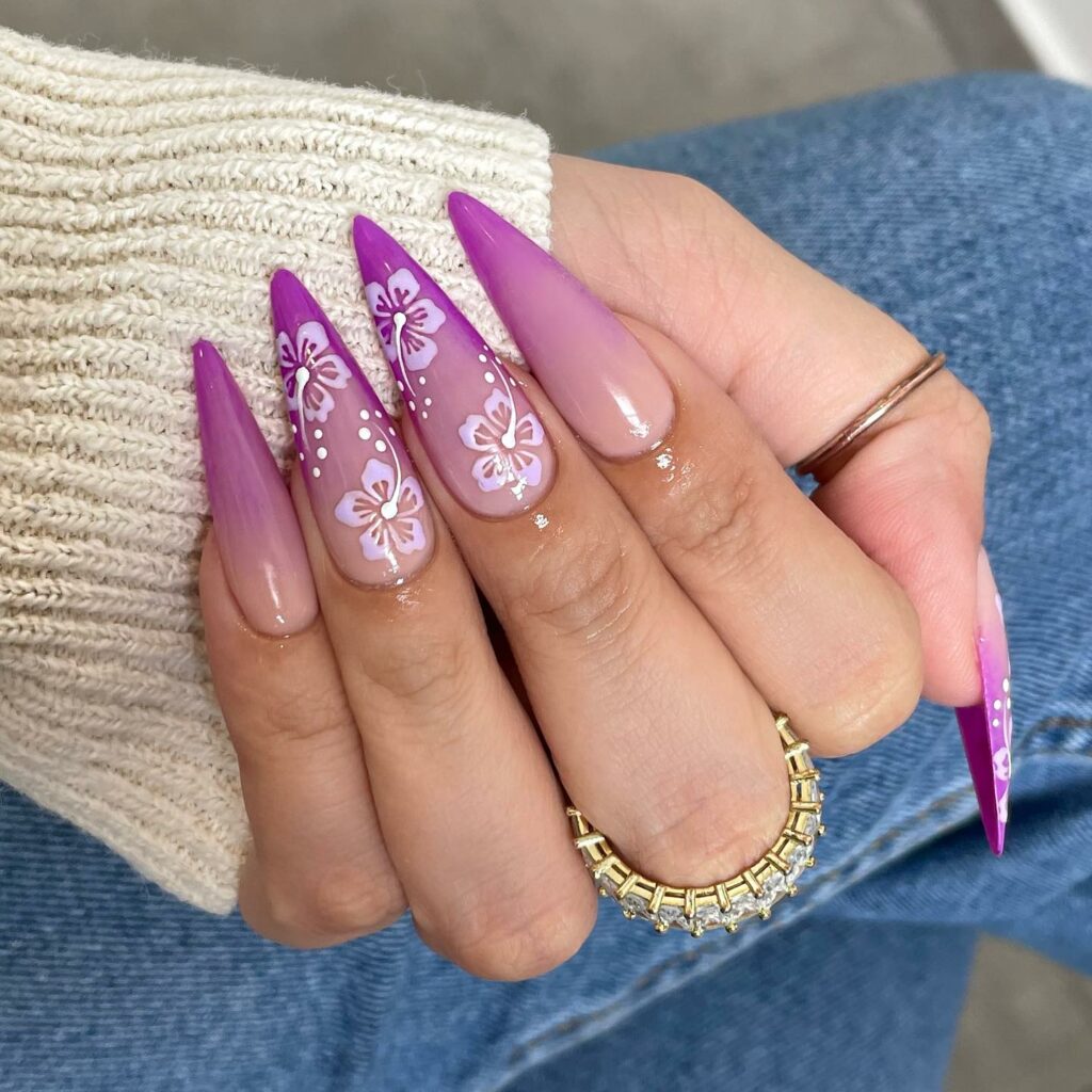 20 Latest Nude Ombre Nail Ideas To Try In 2024! 28 Nude And Purple Stiletto Nails With Hibiscus Design