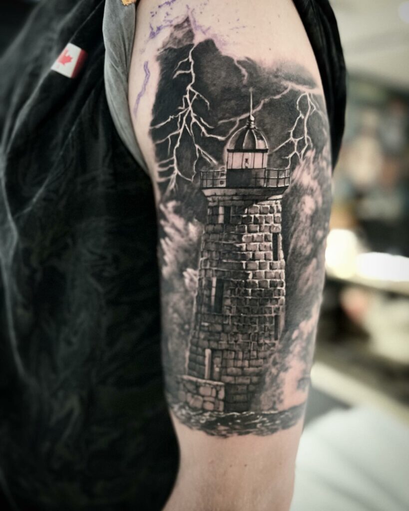 11 LIGHTHOUSE TATTOOS IDEAS + MEANINGS - UPDATED 2024 17 Black & Grey Lighthouse Tattoos