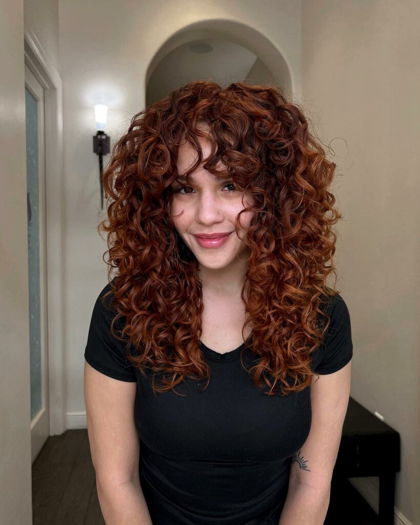 35 Reddish Brown Hair Color Ideas to Try in 2024 37 Auburn Curls with Brunette Roots