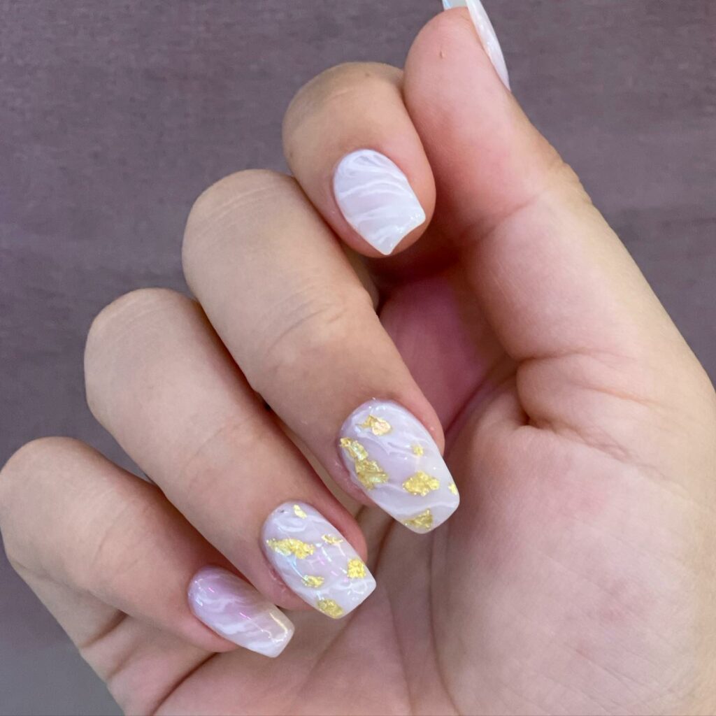 Embrace Elegance with 15 White Marble Nail Designs in 2024 17 White Marble Small Coffin Nails With Gold Flakes