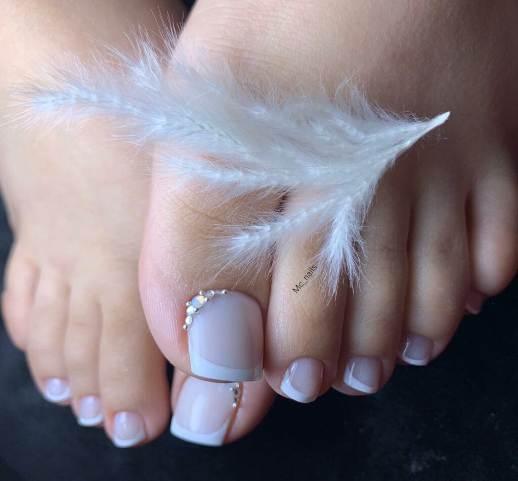 17 Latest Milky White Pedicure Designs To Try In 2024! 10 Milky White French Pedicure With Rhinestones