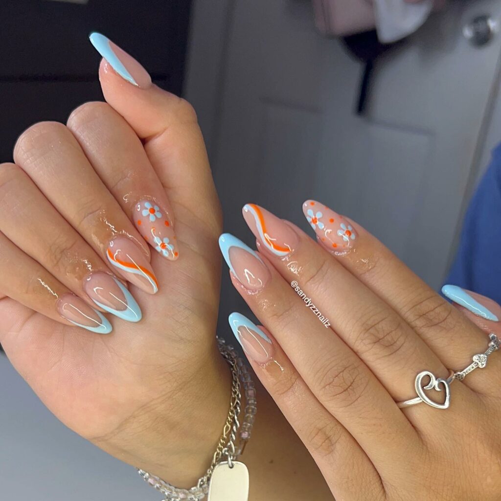 20 Latest Orange And Blue Nail Ideas To Try In 2024! 26 Orange And Blue Nails With Swirl And Flower Design