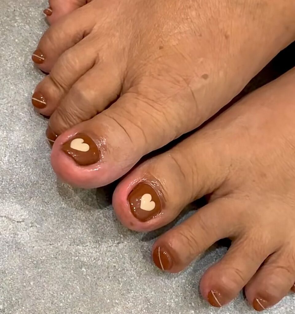 Get Playful with 30 Heart Toenail Pedicure Ideas for 2024 13 Heart Nail Art On A Brown Base Pedicure