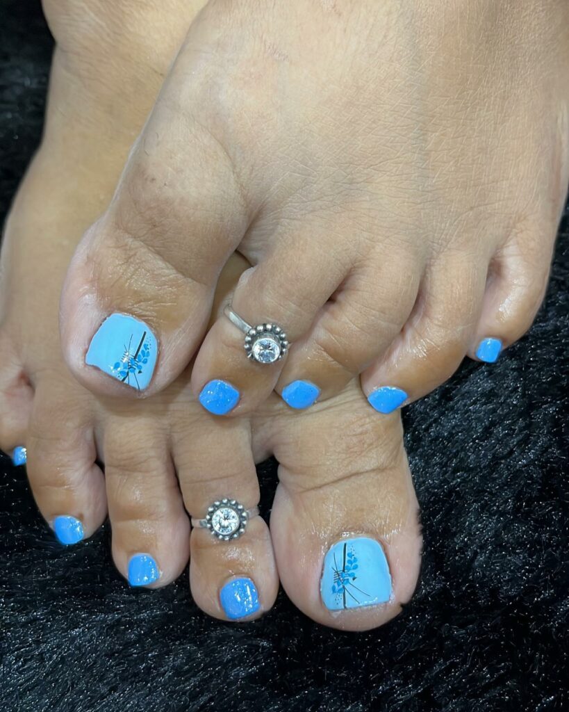 30 Light Blue Pedicure Ideas to Try in 2024 25 Light Blue With A Blue Flower Design
