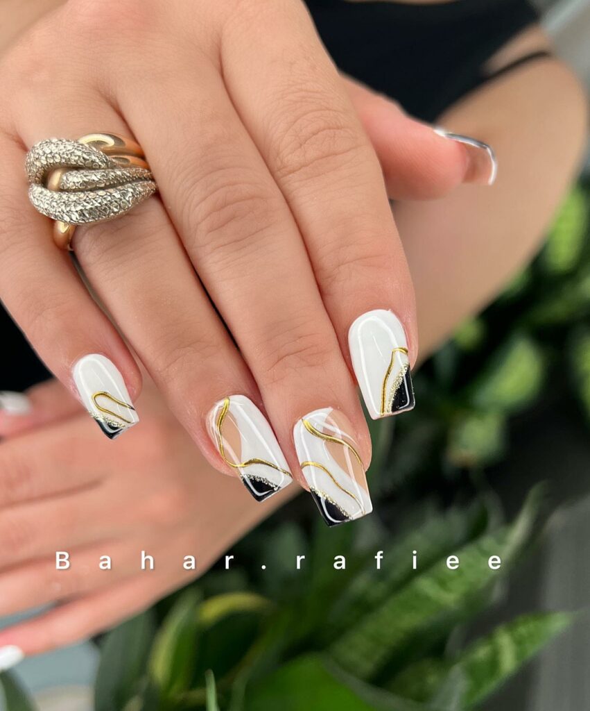 30 Latest White And Gold Nail Ideas To Try In 2024! 18 White Nails With Gold Swirls And Side French Tips