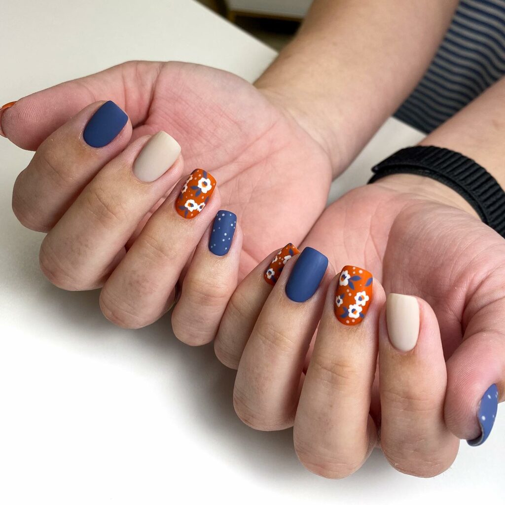 20 Latest Orange And Blue Nail Ideas To Try In 2024! 28 Orange And Blue Matte Nails With Daisy Flower Design