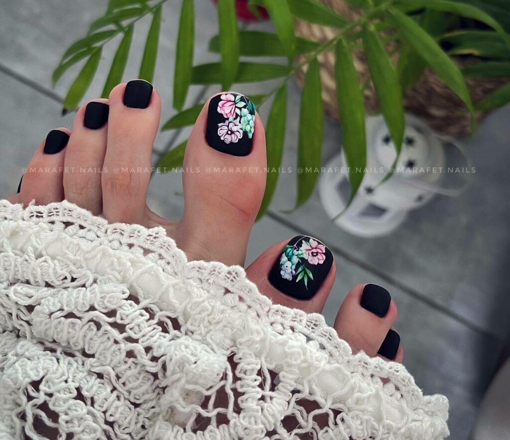20 Latest Flower Pedicure Designs To Try In 2024! 12 Black Base Pedicure With Colorful Flower Design